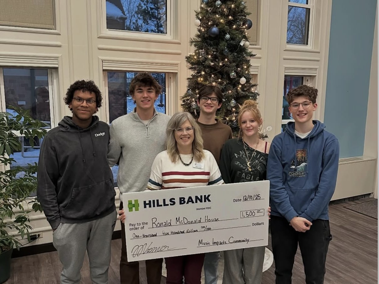 Music Impacts Community team presenting a $1,500 donation check to Ronald McDonald House